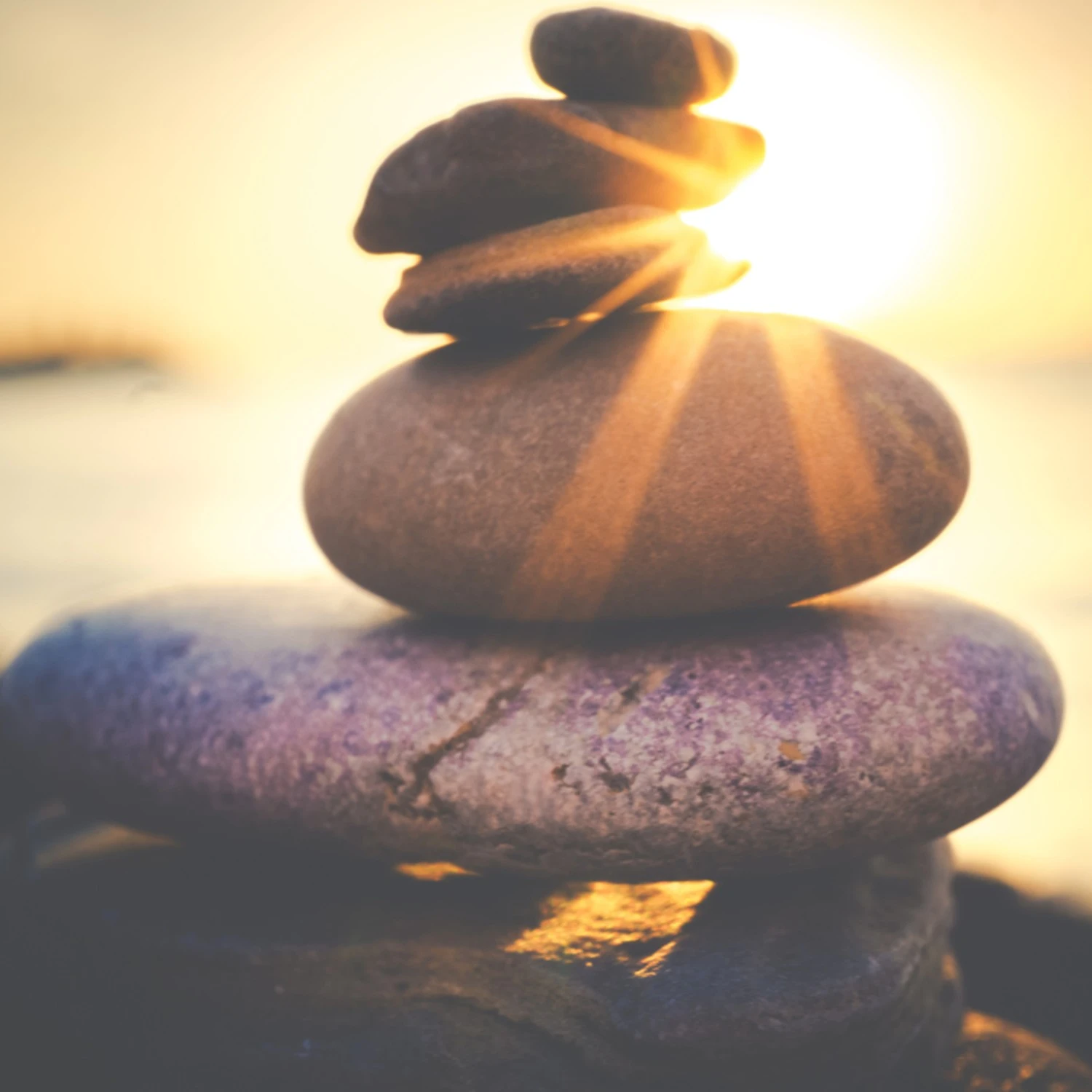 tacked zen stones at sunset representing calm and balance - InnerZension Therapy anxiety treatment in Lowell